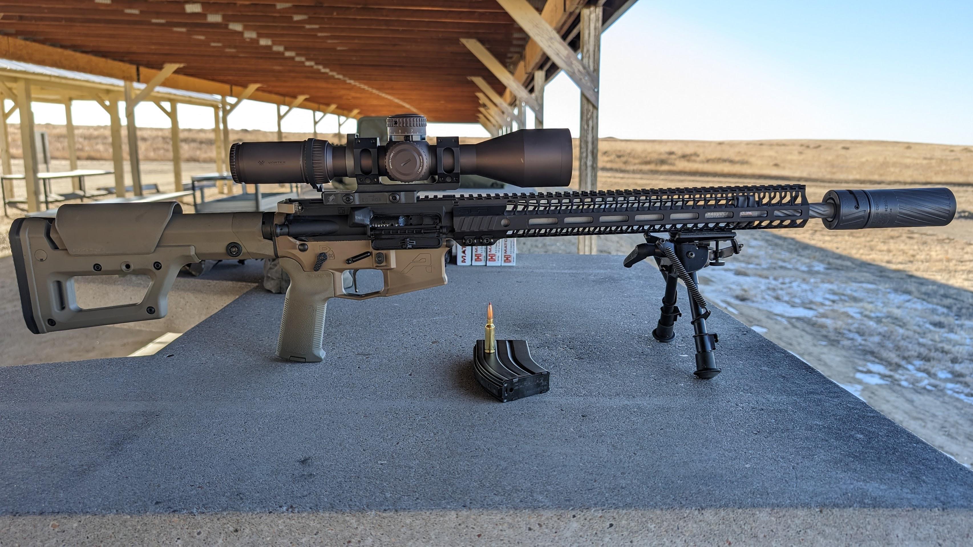 ^mm ARC ar-15 rifle with bipod sitting on a shooting rest at the range ^mm ARC ar-15 rifle with bipod sitting on a shooting rest at the range